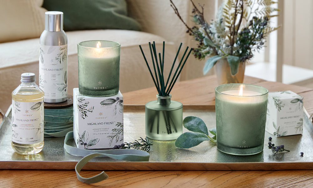 Thymes Highland Frost collection on a coffee table