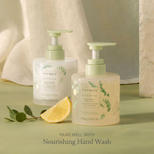 Two Thymes eucalyptus hand wash and lotion with a lemon wedge and green leaves on a light green background.