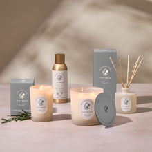 Thymes product line including candles, diffuser, and bottle on a neutral background