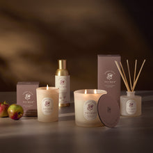 Thymes product line including candles, diffuser, and bottle on a dark background