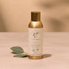 Thymes home fragrance diffuser bottle with gold cap on a beige background