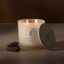 Thymes candle with a label on a brown background