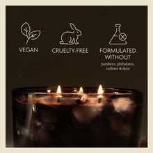 Candle with vegan, cruelty-free, and sulfate-free icons on a dark background