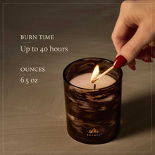 Candle being lit with text about burn time and size, featuring the Thymes brand.