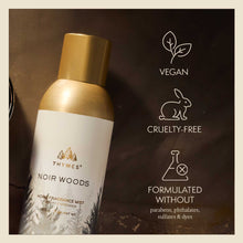 Thymes Noir Woods home fragrance mist bottle with vegan, cruelty-free, and paraben-free icons on a dark background.