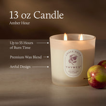 Thymes candle with apple next to it on a dark background