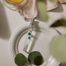 Thymes Eucalyptus White Tea Cologne Spray Pen is Travel Sized flat lay next to eucalyptus botanicals