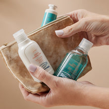 Holding Thymes Aqua Coralline Travel Set in Hands