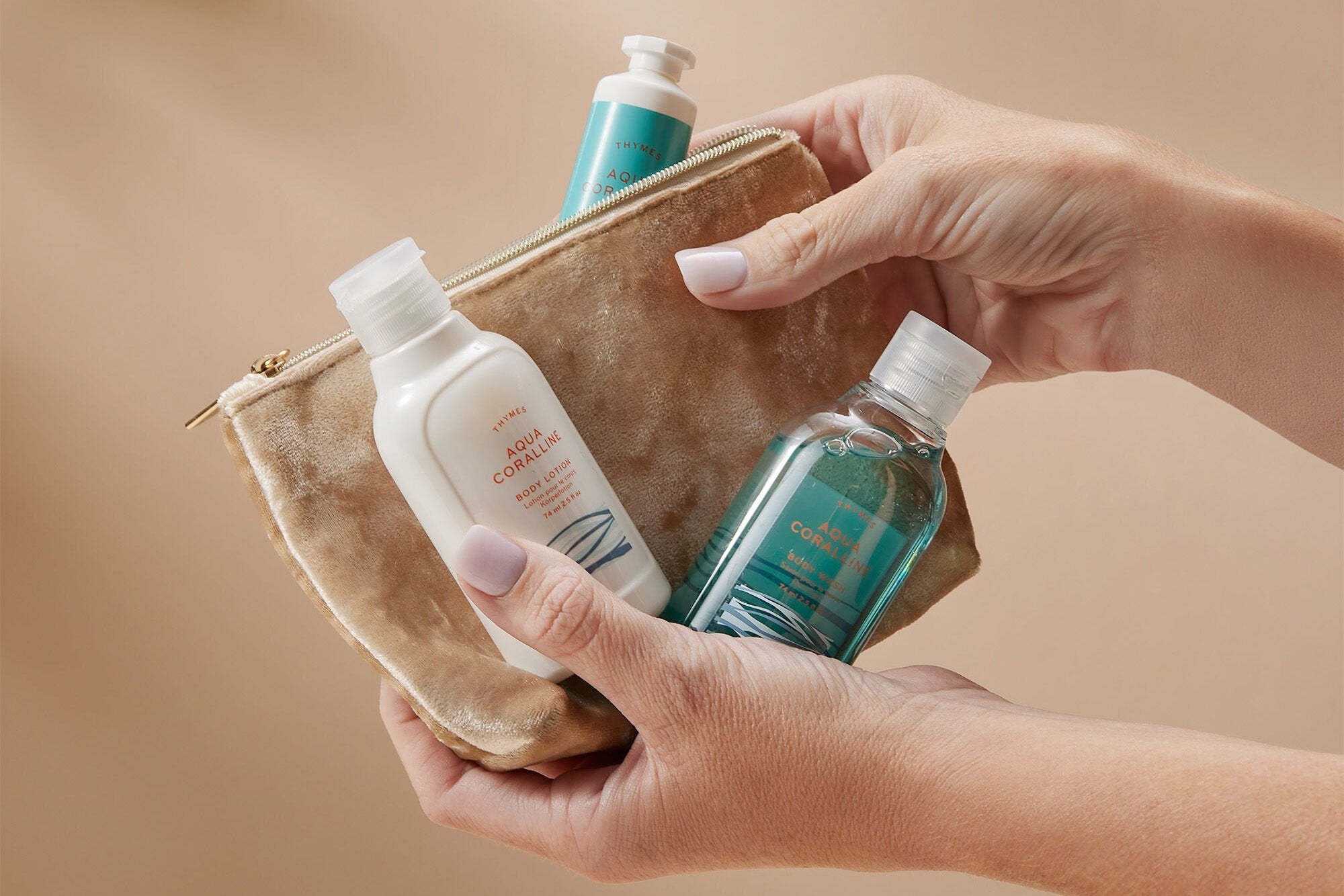 Holding Thymes Aqua Coralline Travel Set in Hands