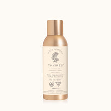 Thymes home fragrance mist bottle with gold cap on a white background
