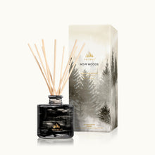 Thymes Noir Woods diffuser with packaging featuring a forest design on a white background