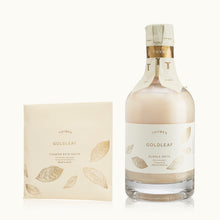 Bottle and packaging of Thymes Goldleaf bubble bath on a white background