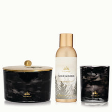 Thymes Noir Woods 3-wick candle, diffuser, and single wick candle on a white background