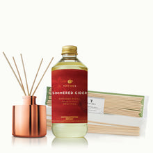Thymes Simmered Cider diffuser refill bottle and reed diffuser with packaging on a white background