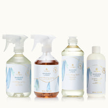 Set of four Thymes Washed Linen cleaning product bottles with labels on a tan background