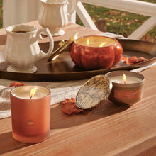 Pumpkin Laurel 15 oz poured candle and 6.5 oz poured candle featured on a wooden surface