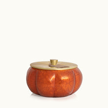 Decorative pumpkin-shaped 15 oz poured candle with a gold lid on a white background