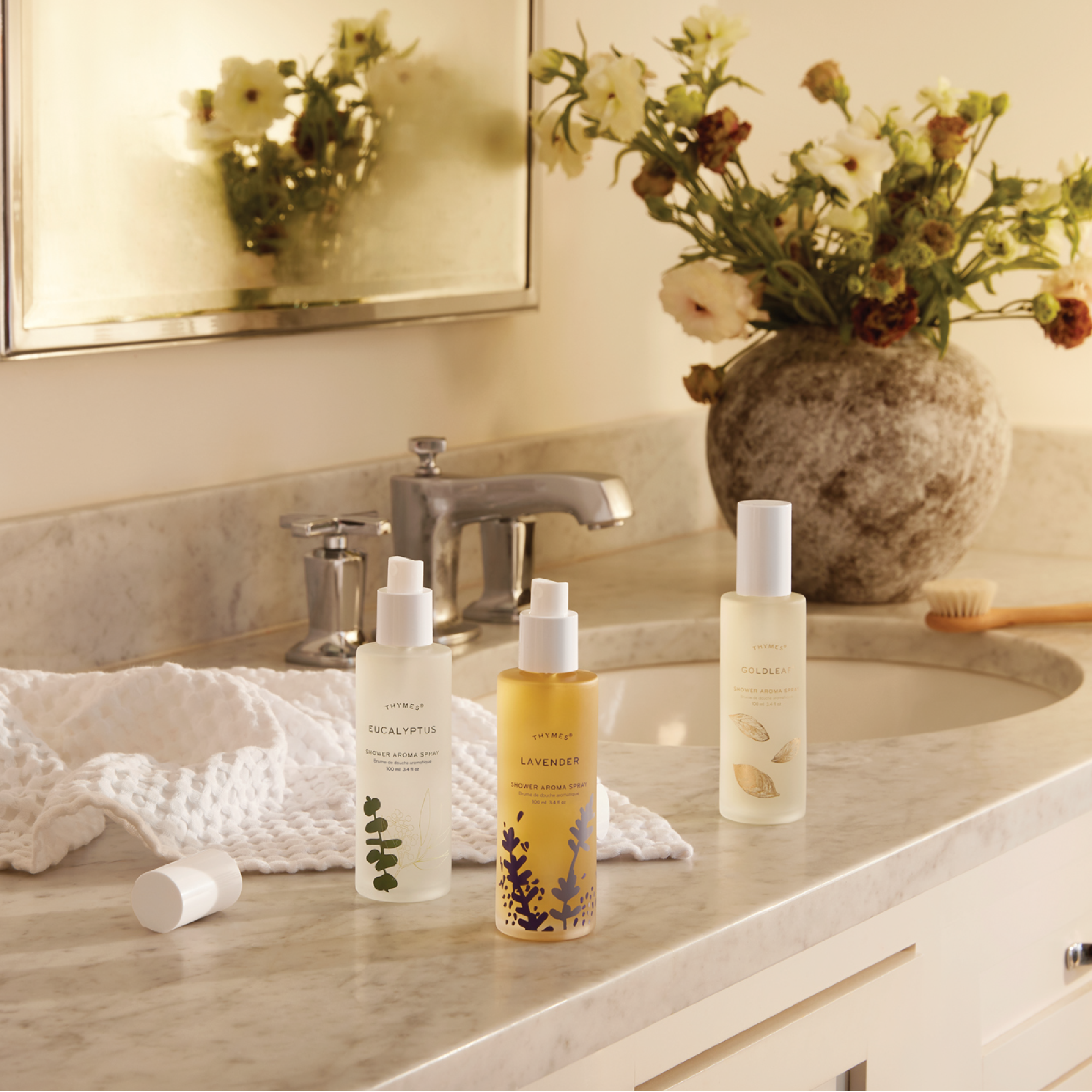 Thymes Shower Aroma Sprays on a bathroom countertop