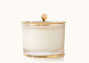 Thymes Frasier Fir in the Gilded finish featuring frosted wood grain candles