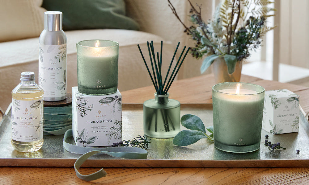 Thymes Highland Frost collection on a coffee table