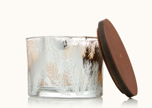 An assortment of Thymes Frasier Fir candles on a dining table