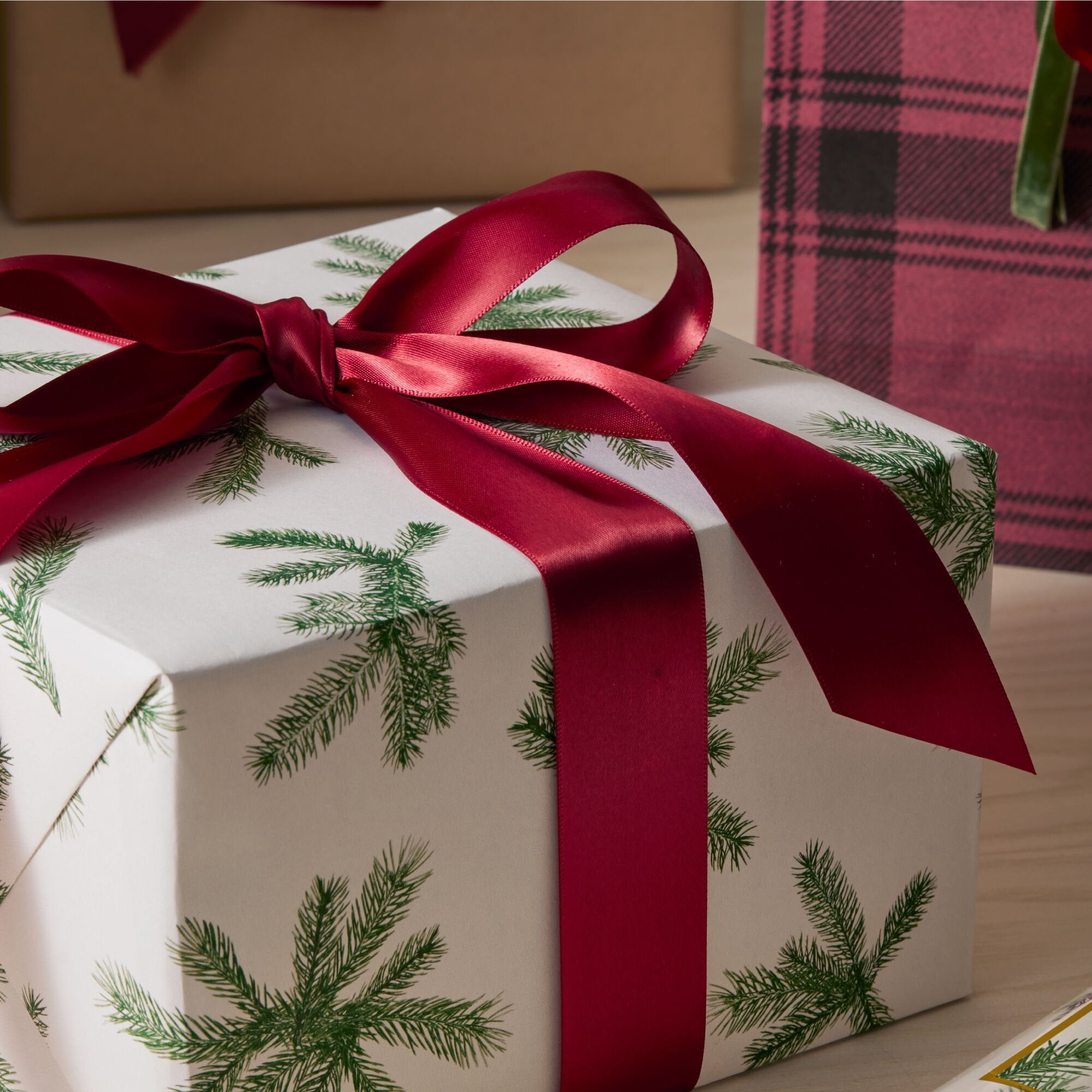 A present wrapped in Thymes Frasier Fir scented wrapping paper