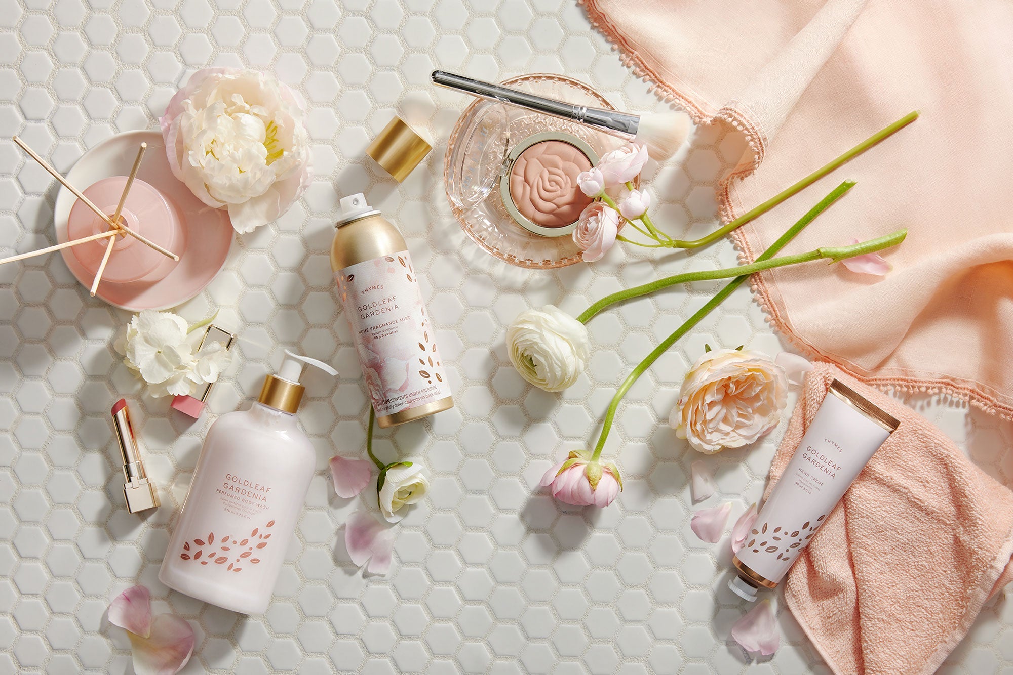 Thymes Goldleaf Gardenia fragrance collection featuring home fragrance mist, hand cream, body wash and diffuser