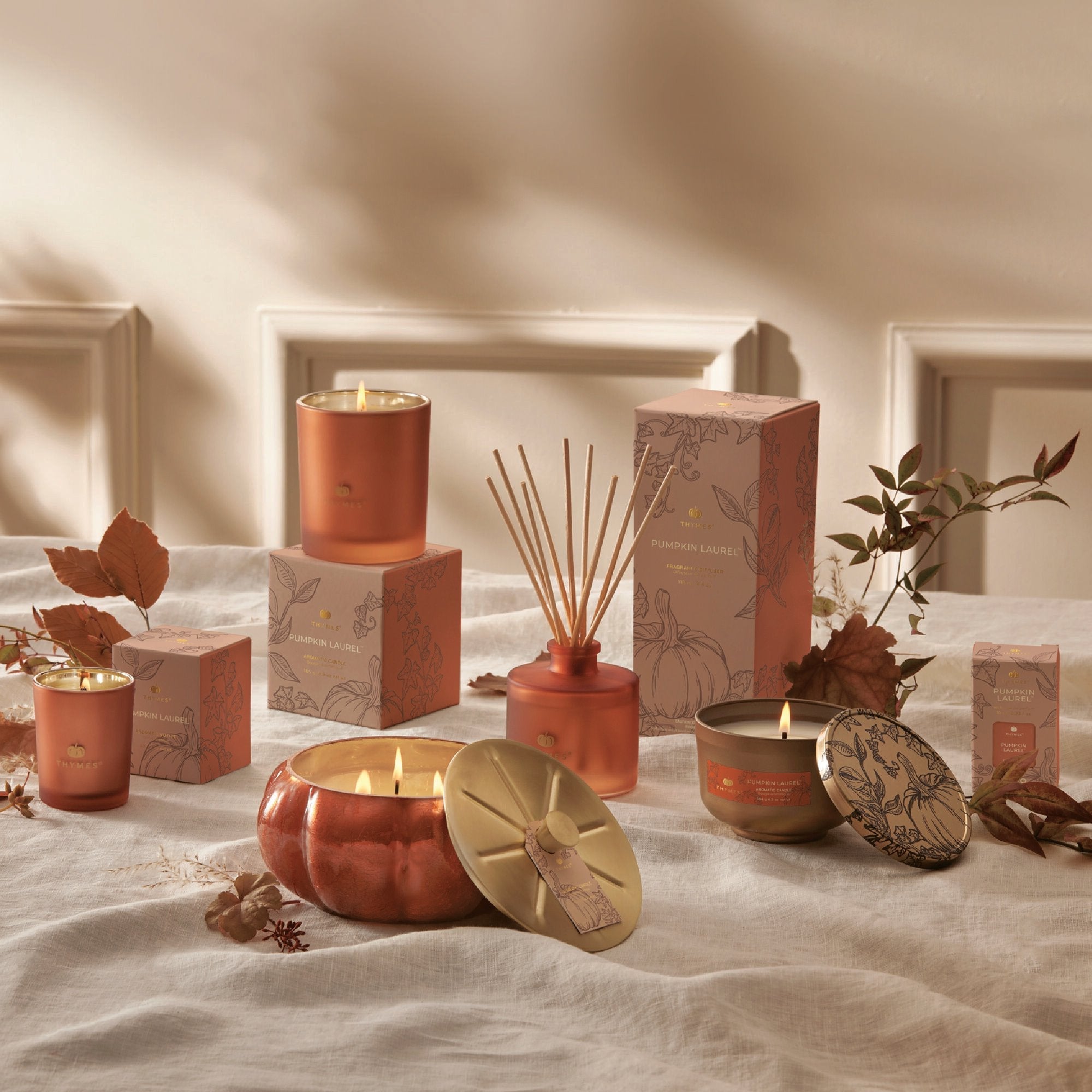 Thymes Pumpkin Laurel fragrance collection featuring candles and diffusers