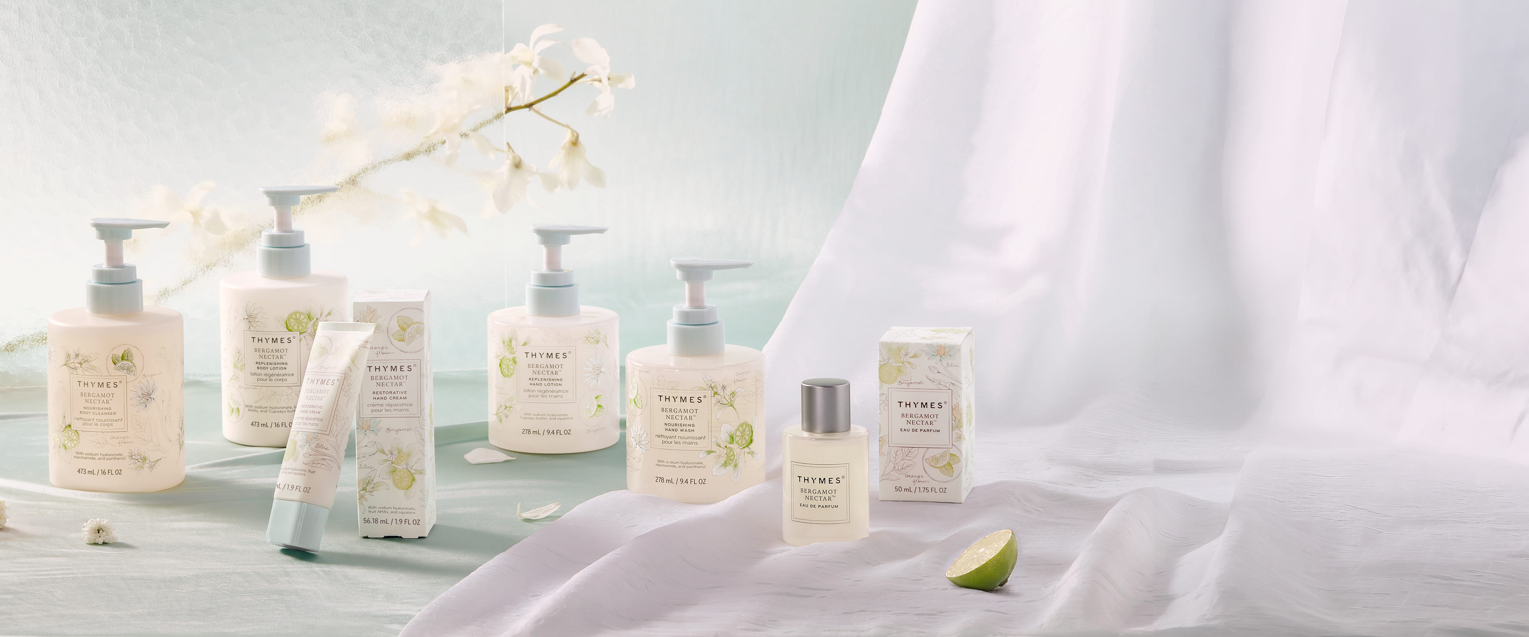 Set of skincare products on a light background with a white curtain.