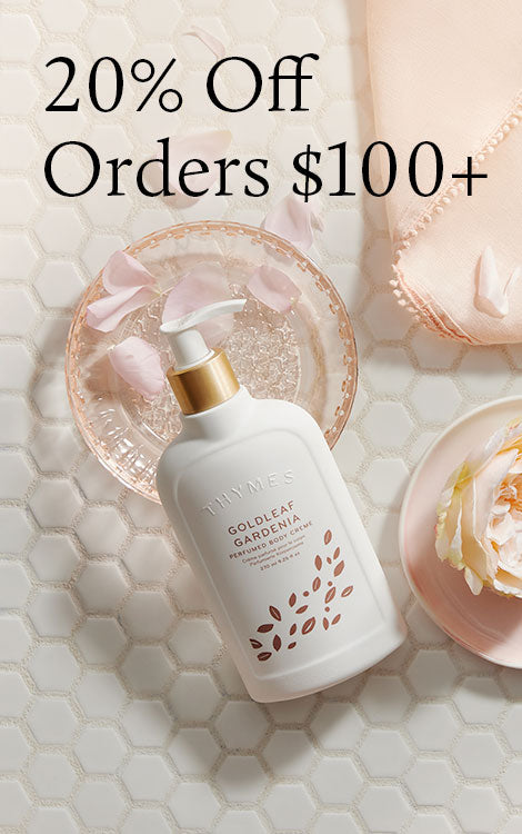 White bottle with gold cap on a textured surface with decorative elements and promotional text.