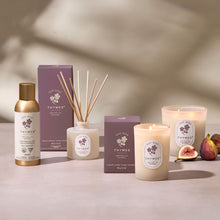 Thymes product line including candles, diffuser, and boxes on a neutral background