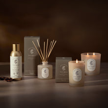 Thymes product line including candles, diffuser, and bottle on a dark background