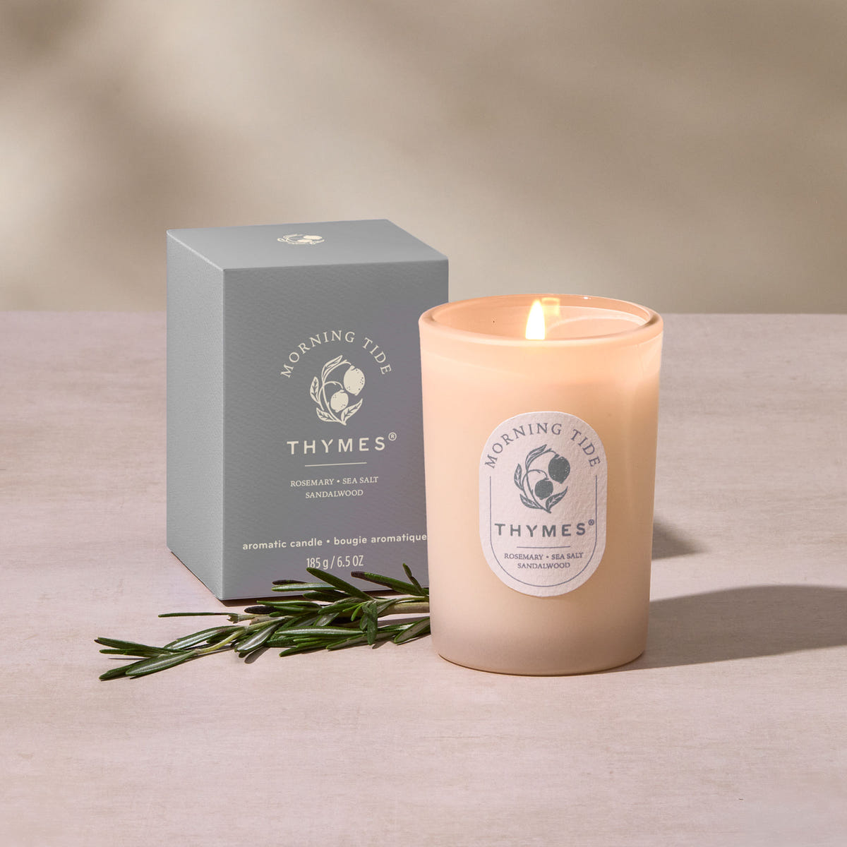 Alternate image of Thymes candle and packaging on a neutral background
