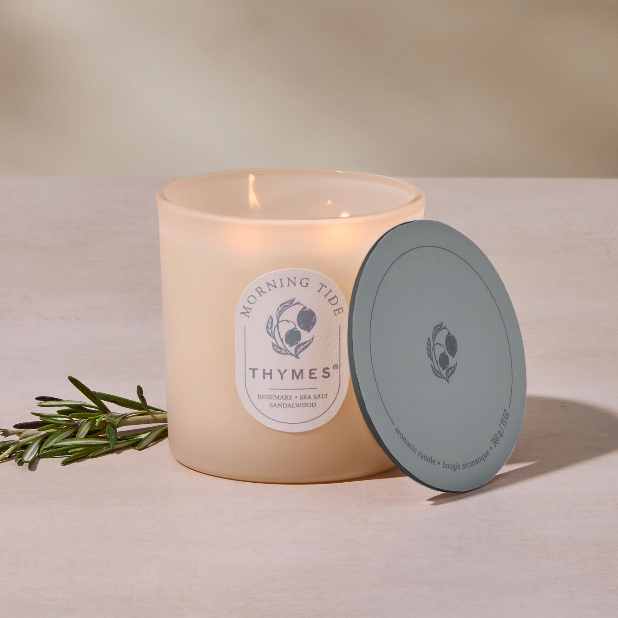 Thymes candle with lid on a neutral background