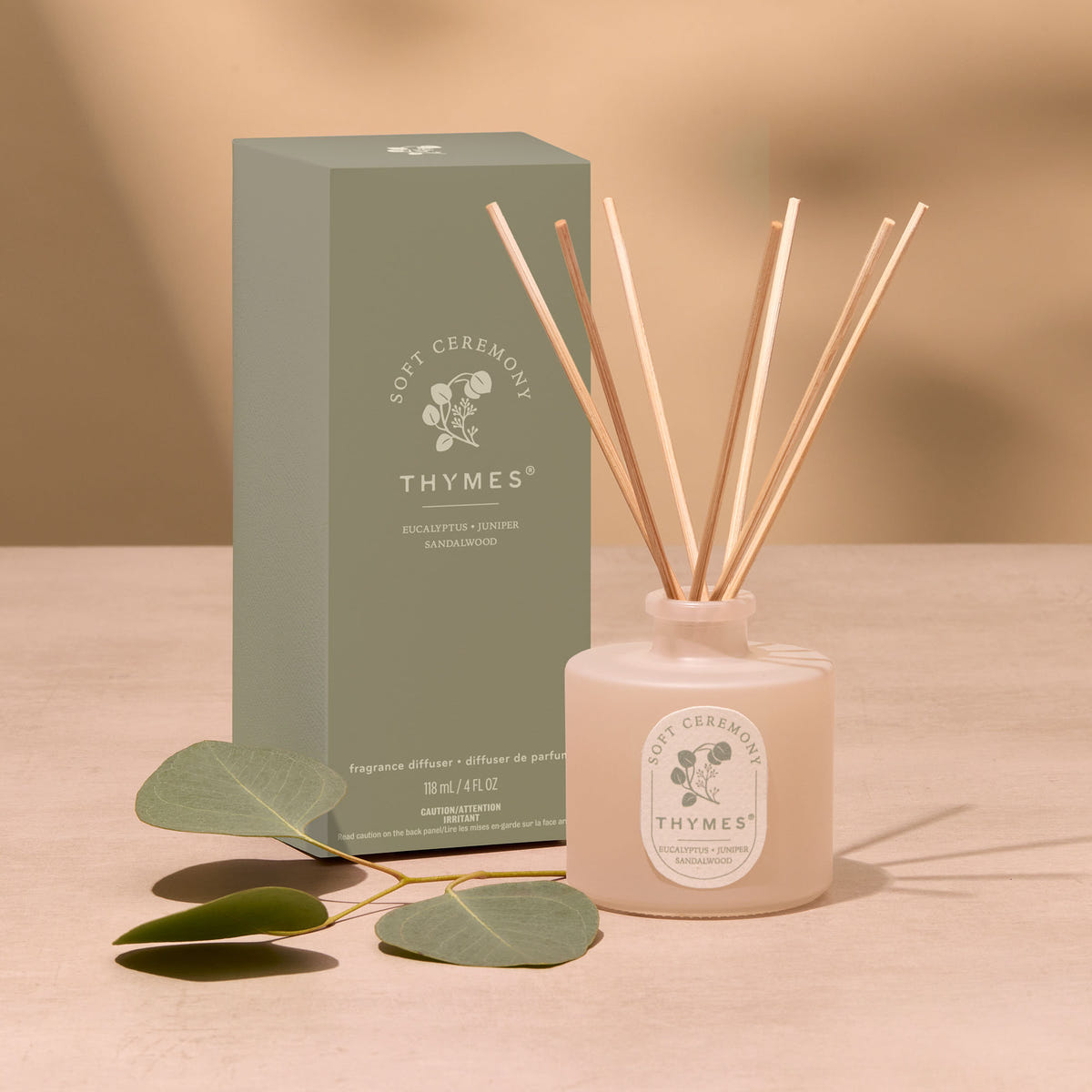 Alternate image of Thymes diffuser with reeds and packaging on a beige background