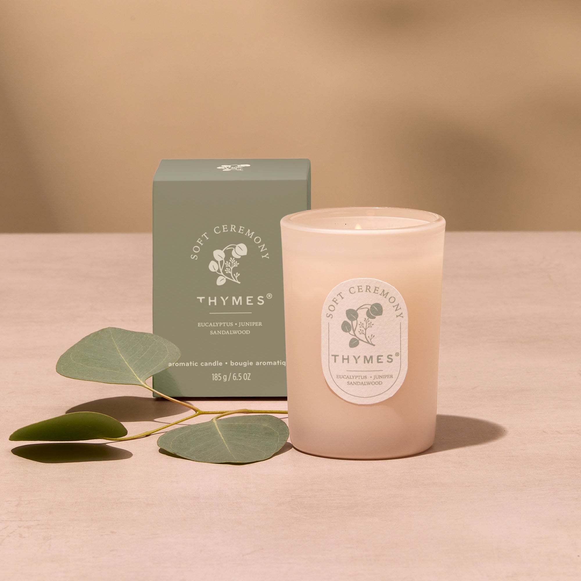 Thymes candle and packaging on a beige background