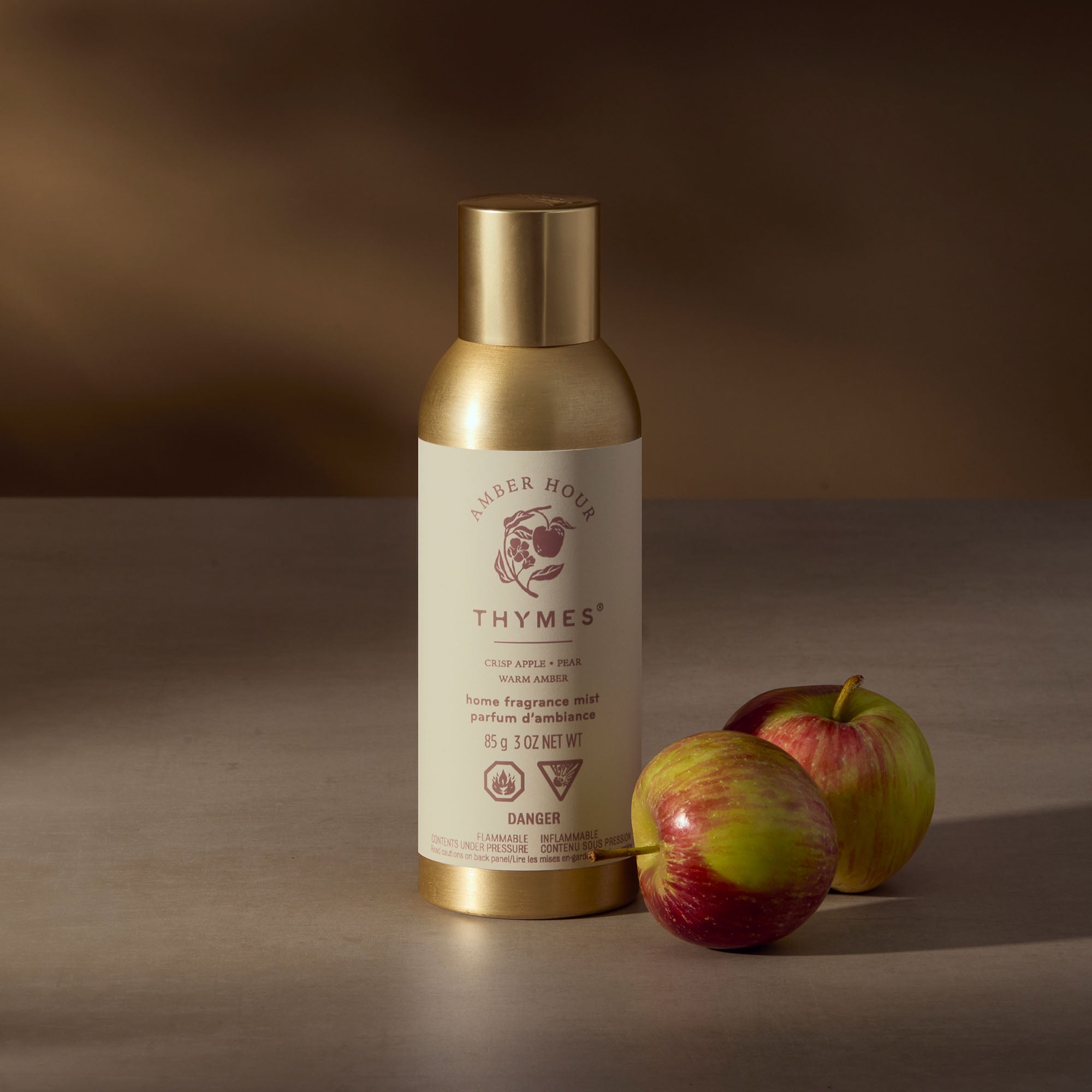 Thymes air freshener bottle with apples on a brown background