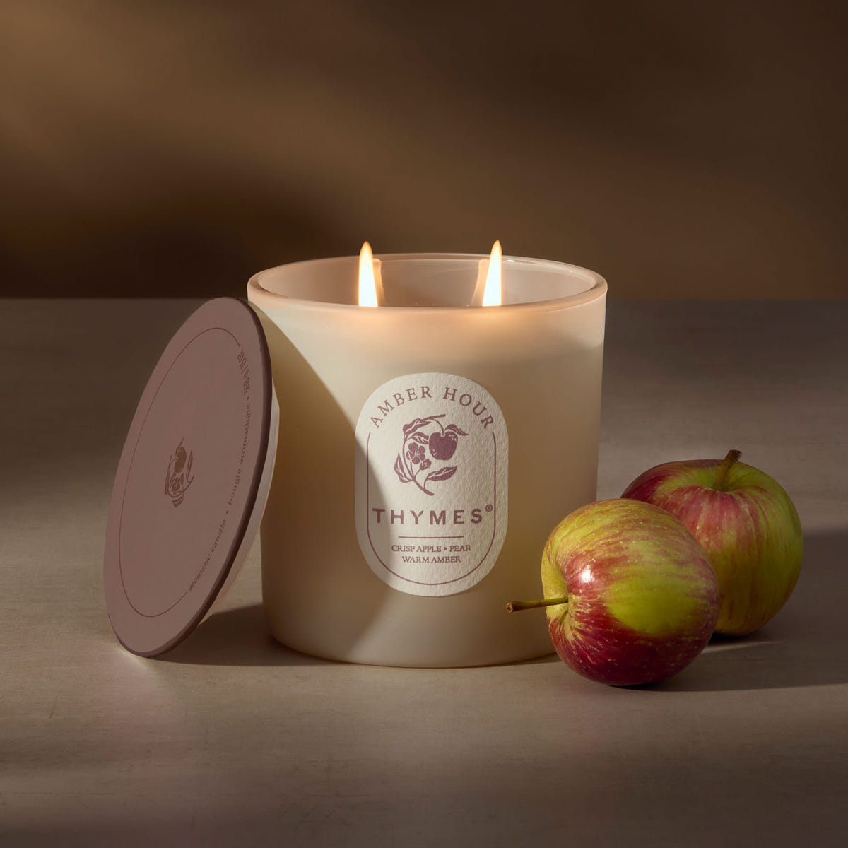 Alternate image of Thymes candle with two apples on a neutral background