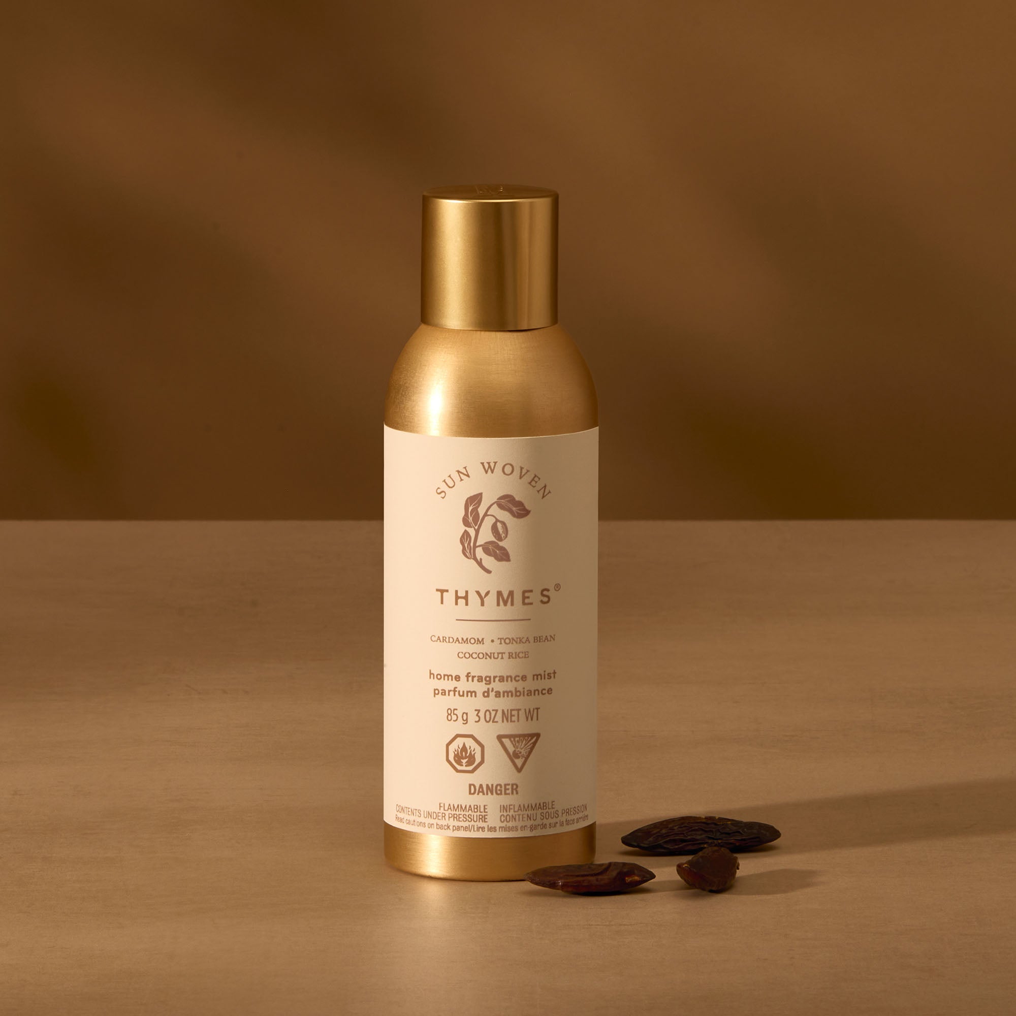 Thymes product with gold cap and label on a brown background
