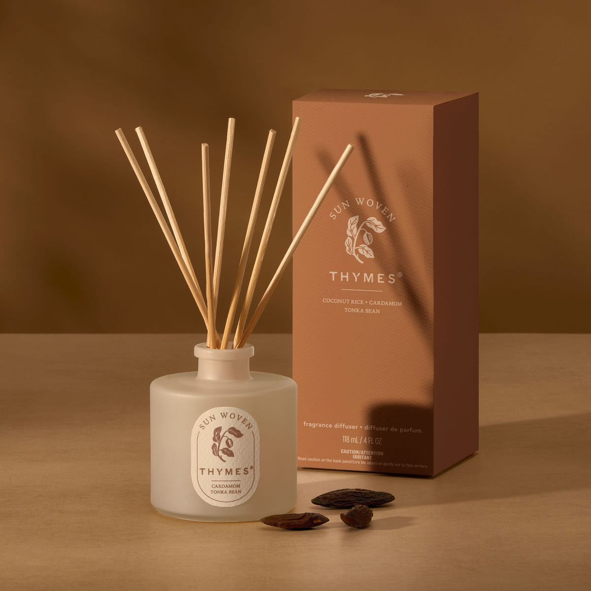 Alternate image of Thymes diffuser bottle with wooden sticks and packaging on a brown background