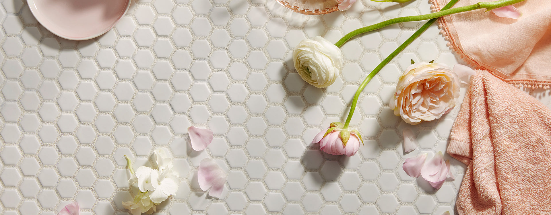 Flower on tile floor with a towel