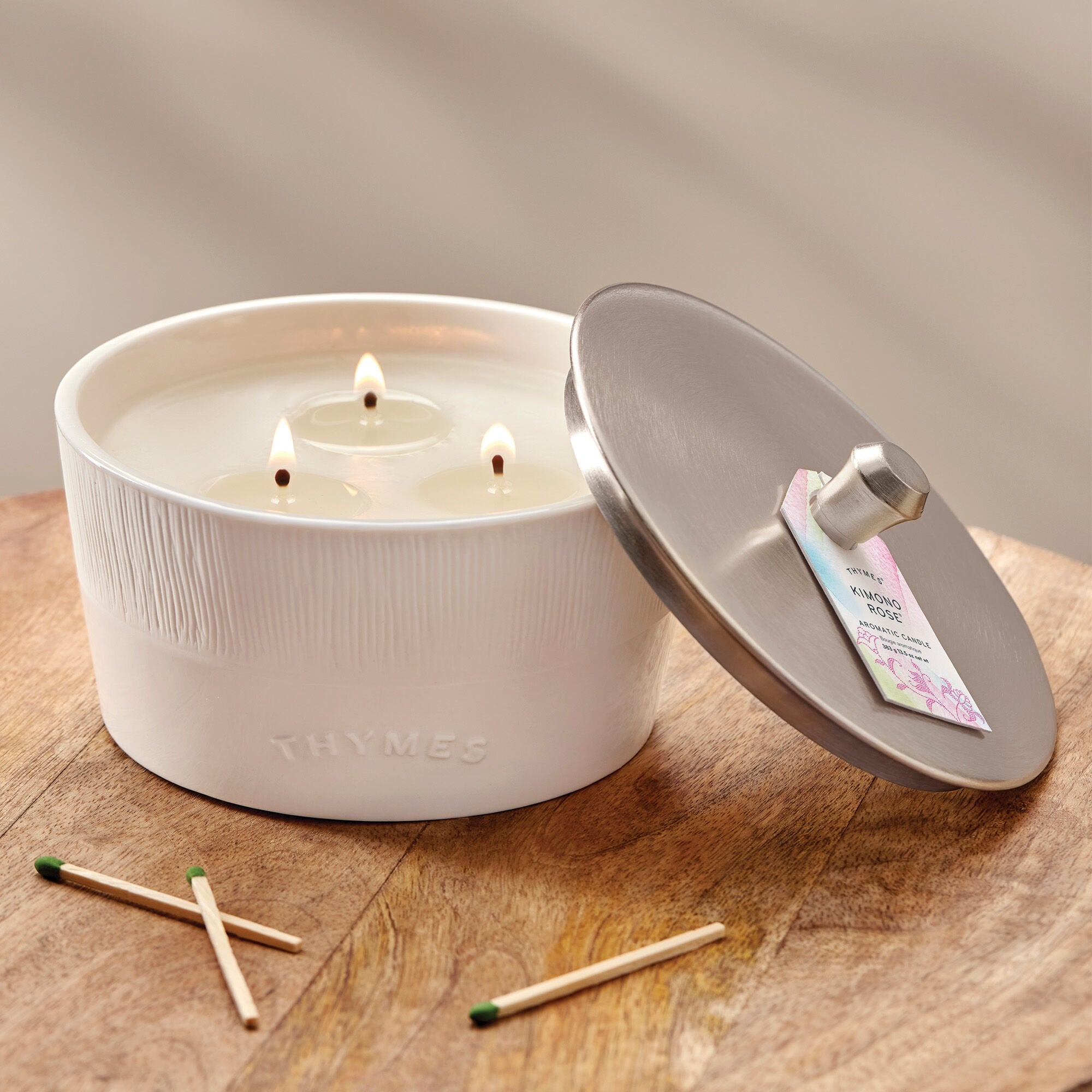 Thymes Kimono Rose 3-Wick Candle on table