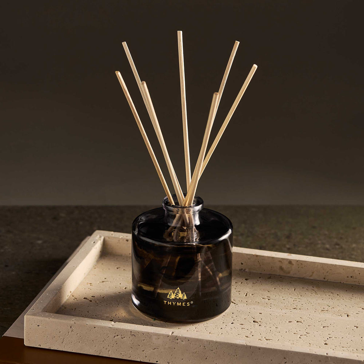 Alternate image of Black diffuser with wooden sticks on a stone surface