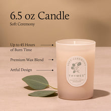 Thymes candle with label and leaf on beige background