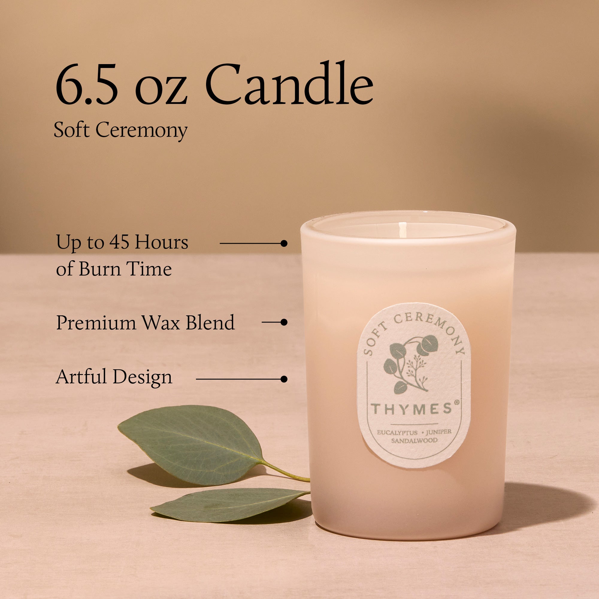 Thymes candle with label and leaf on beige background