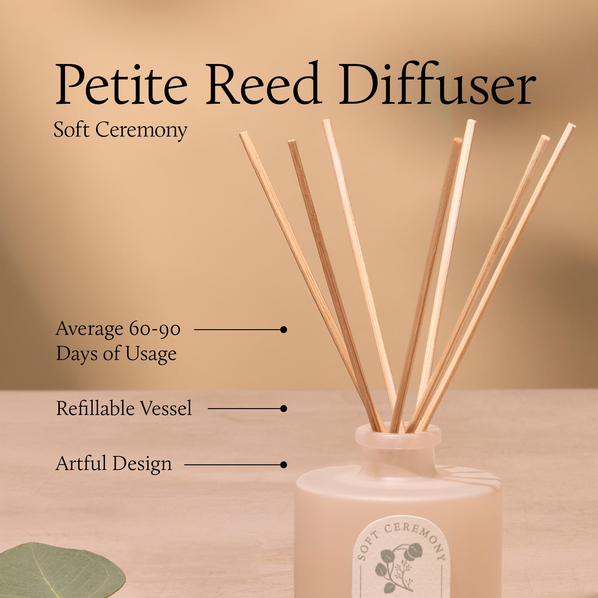 Petite reed diffuser with wooden sticks and a pink container on a beige background