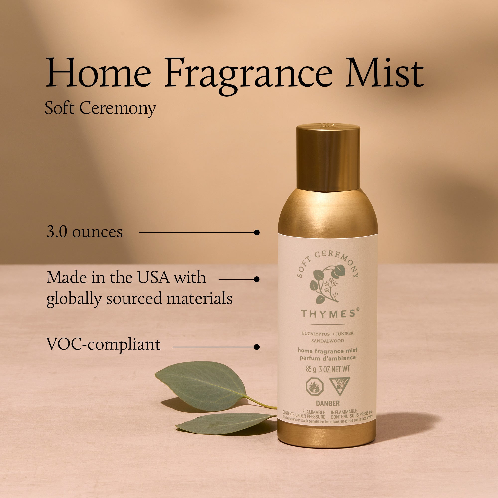 Thymes home fragrance mist bottle with gold cap on a beige background