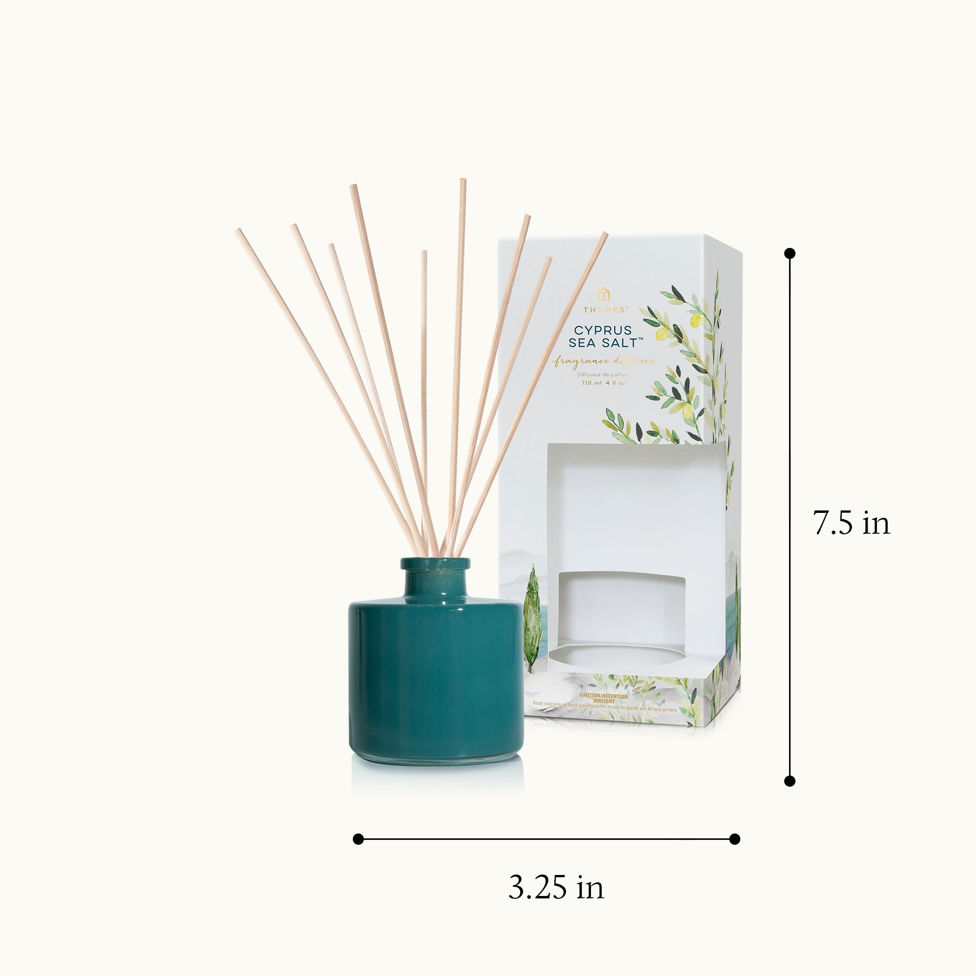 Teal diffuser bottle with wooden sticks and packaging on a white background