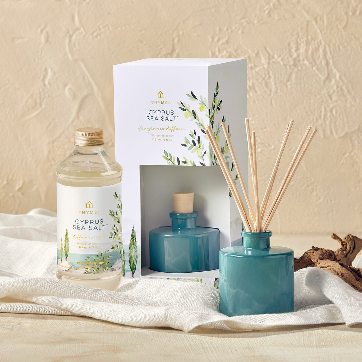 Alternate image of Diffuser set with bottle, packaging, and reeds on a textured surface