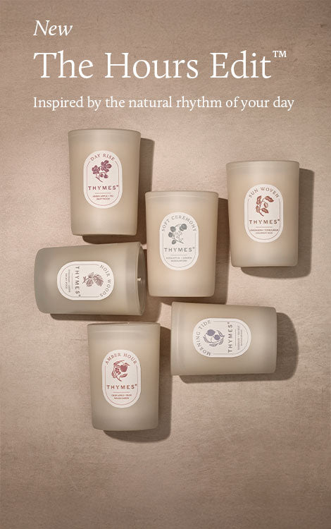 Set of six candles labeled 'Thymes' on a beige background with text about 'The Hours Edit'.